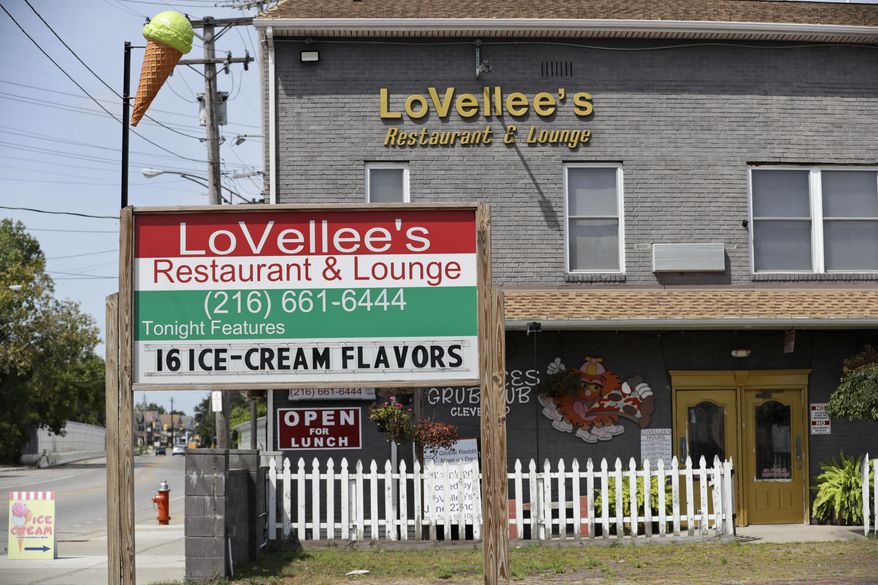 This Friday, Aug. 30, 2019 photo, shows an apartment building, located above a pizzeria, that was the scene of a New Years Eve party shooting in Cleveland. Olympic gymnastics champion Simone Biles says she's struggling with the arrest of her brother, Tevin Biles-Thomas, who was charged in the shooting that left three dead. Biles-Thomas was arrested in Georgia last week after being indicted on murder, manslaughter and other charges in a New Year's Eve party shooting. (AP Photo/Tony Dejak)