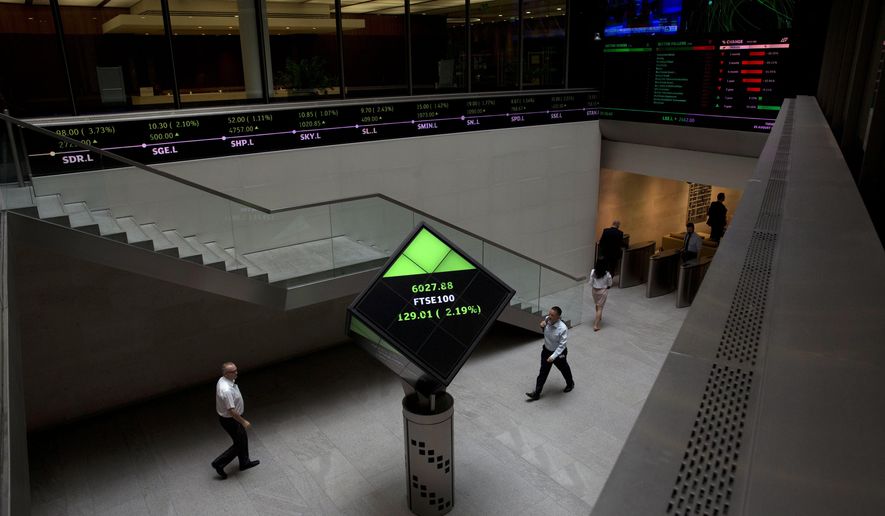 FILE - In this Tuesday, Aug. 25, 2015 file photo, Financial information is displayed on screens and a ticker inside the London Stock Exchange in the City of London. The London Stock Exchange is rejecting an unsolicited takeover bid from its Hong Kong counterpart, citing “fundamental concerns” about the offer. The London Stock Exchange said Friday, Sept. 13, 2019 that it sees “no merit” in going forward with the offer because of the concerns. (AP Photo/Matt Dunham, file)