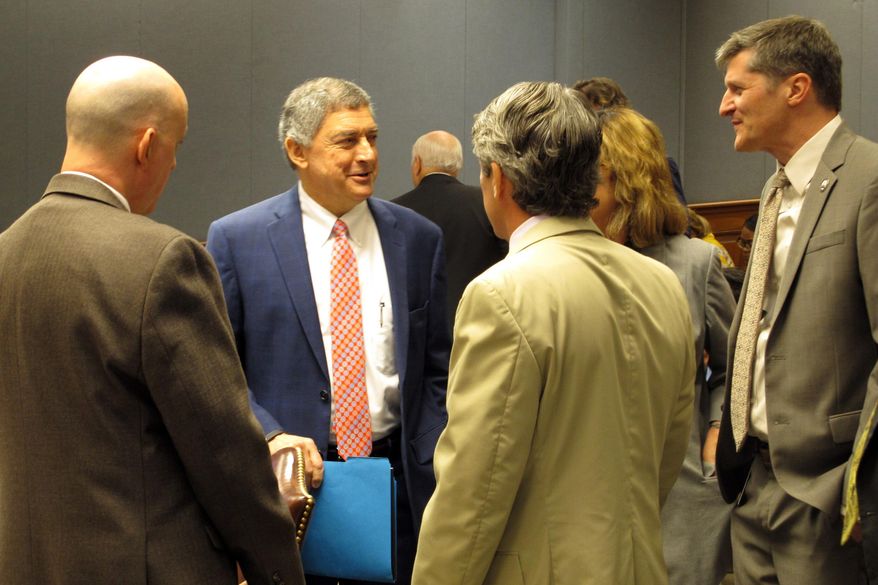 Commissioner of Administration Jay Dardenne, second from left, the governor's chief budget adviser, speaks to budget analysts and lawmakers at the House and Senate budget committee meeting on Friday, Sept. 13, 2019, in Baton Rouge, La. Dardenne told lawmakers that Louisiana's surplus estimate has grown to $500 million. (AP Photo/Melinda Deslatte)