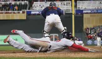 Washington Nationals&#39; left fielder Juan Soto, right, scores on a triple by Asdrubal Cabrera as Minnesota Twins&#39; catcher Mitch Garver chases the ball in the fifth inning of a baseball game Thursday, Sept. 12, 2019, in Minneapolis. (AP Photo/Jim Mone)