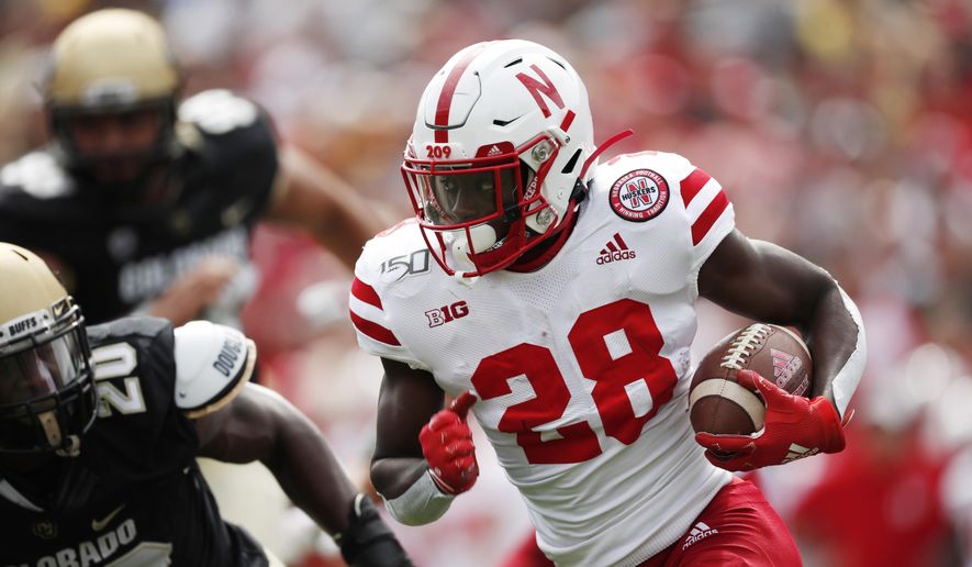 Nebraska running back Maurice Washington (28) drives for a short gain as Colorado linebacker Davion Taylor (20) comes in for the tackle in the first half of an NCAA college football game Saturday, Sept. 7, 2019, in Boulder, Colo. (AP Photo/David Zalubowski)