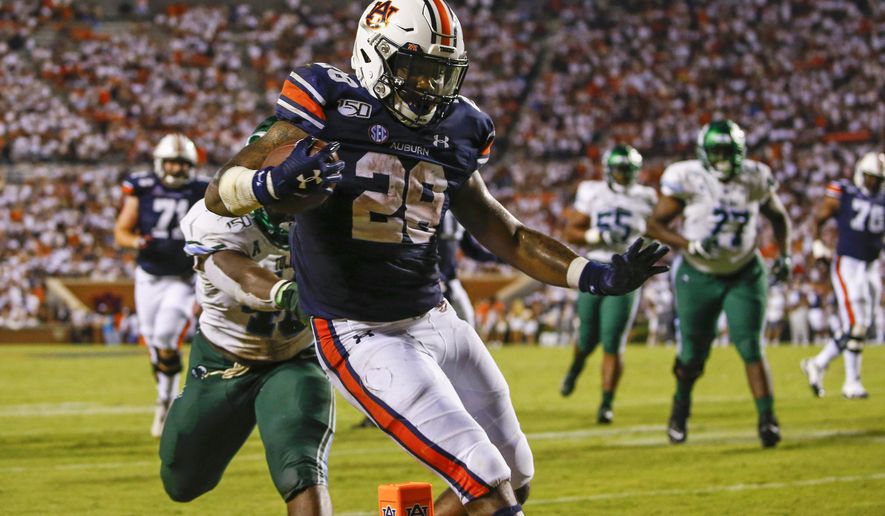 Auburn running back JaTarvious Whitlow (28) carries the ball in for a touchdown during the second half of the team's NCAA college football game against Tulane, Saturday, Sept. 7, 2019, in Auburn, Ala. (AP Photo/Butch Dill)