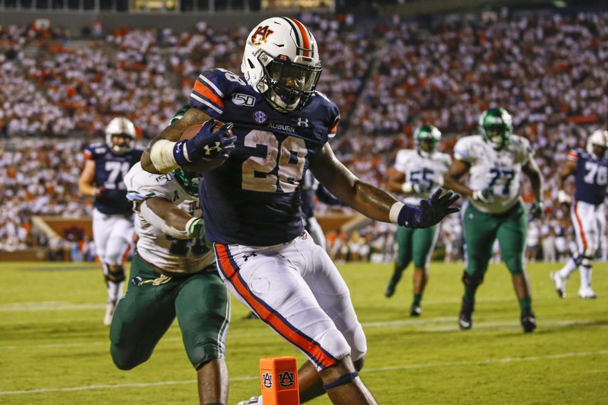 Auburn running back JaTarvious Whitlow (28) carries the ball in for a touchdown during the second half of the team's NCAA college football game against Tulane, Saturday, Sept. 7, 2019, in Auburn, Ala. (AP Photo/Butch Dill)