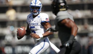 Air Force quarterback Donald Hammond III, left, is pursued by Colorado safety Mikial Onu in the first half of an NCAA college football game Saturday, Sept. 14, 2019, in Boulder, Colo. (AP Photo/David Zalubowski)