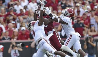 South Carolina&#39;s Shi Smith, center, catches a touchdown pass while defended by Alabama&#39;s Jordan Battle, left, and Shyheim Carter during the first half of an NCAA college football game Saturday, Sept. 14, 2019, in Columbia, S.C. (AP Photo/Richard Shiro)