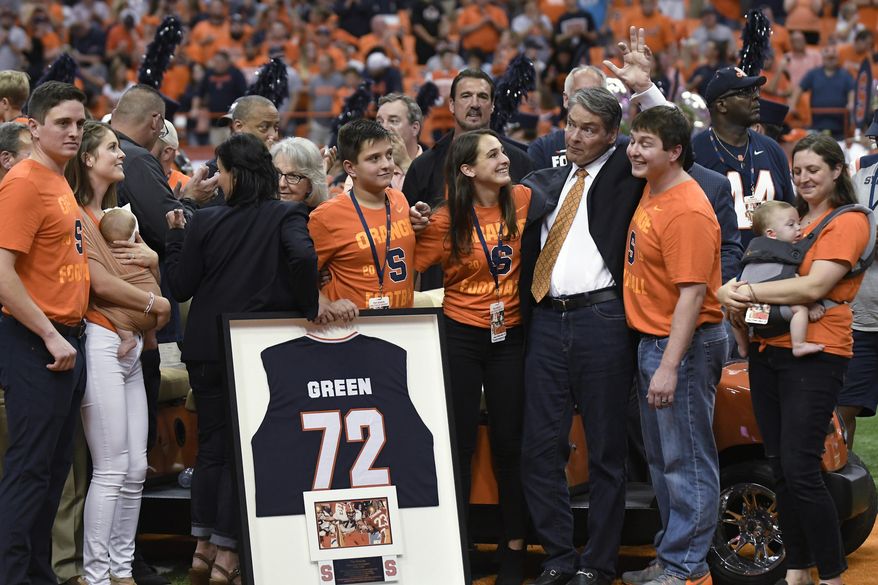 Former Syracuse and NFL football player Tim Green waves as his number is retired during the NCAA college football game between Syracuse and Clemson, Saturday, Sept. 14, 2019, in Syracuse, N.Y. (AP Photo/Steve Jacobs)