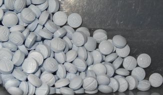 Fentanyl-laced fake oxycodone pills held in evidence are shown in this undated file photo. (U.S. Attorneys Office for Utah via AP) **FILE**