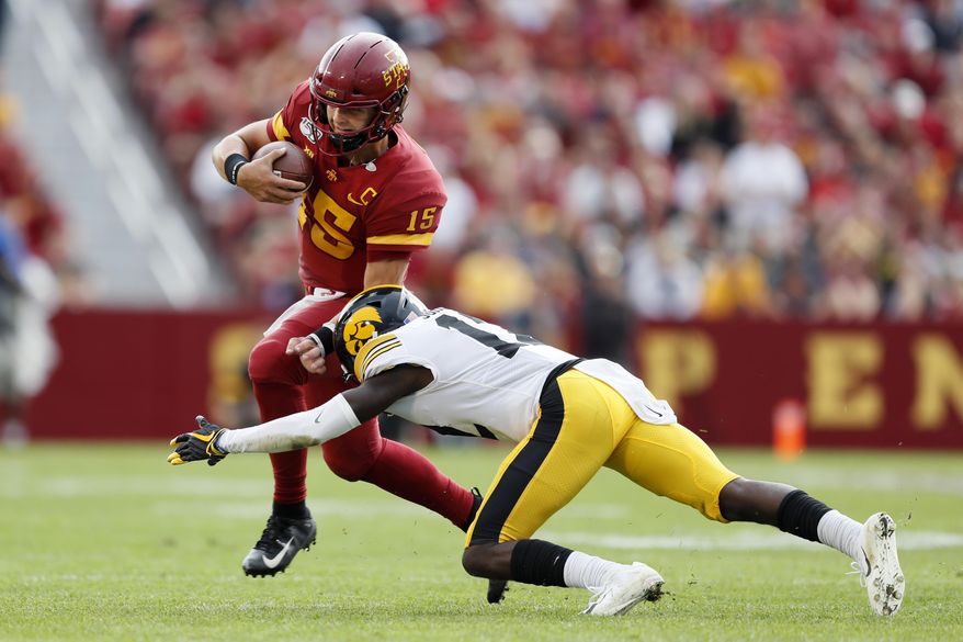 Iowa State quarterback Brock Purdy (15) is tackled by Iowa defensive back D.J. Johnson, right, during the first half of an NCAA college football game, Saturday, Sept. 14, 2019, in Ames, Iowa. (AP Photo/Charlie Neibergall)