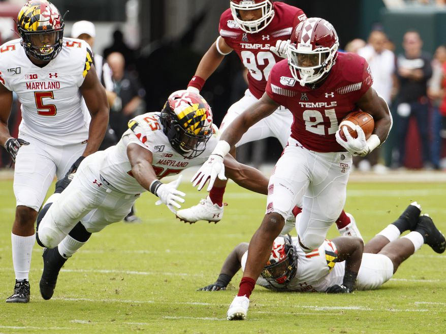 Temple running back Jager Gardner (21) carries with the ball as he tries to get past Maryland defensive back Antoine Brooks Jr. (25) during the first half of an NCAA college football, Saturday, Sept. 14, 2019, in Philadelphia. (AP Photo/Chris Szagola)