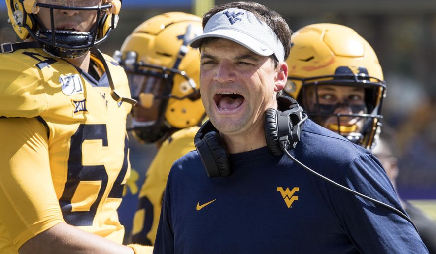 West Virginia head coach Neal Brown yells at a referee during the second half of an NCAA college football game against North Carolina State Saturday, Sept. 14, 2019, in Morgantown, W.Va. (AP Photo/Raymond Thompson)