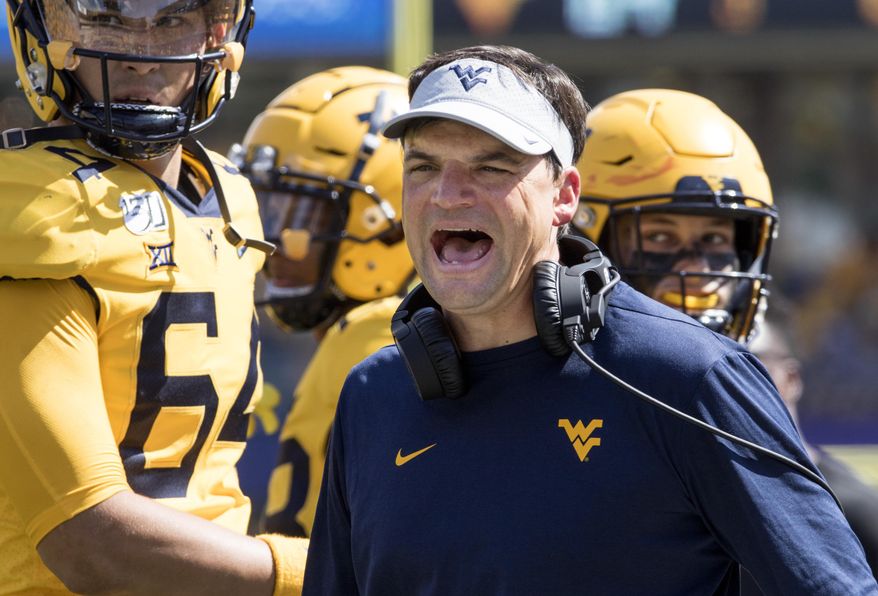 West Virginia head coach Neal Brown yells at a referee during the second half of an NCAA college football game against North Carolina State Saturday, Sept. 14, 2019, in Morgantown, W.Va. (AP Photo/Raymond Thompson)