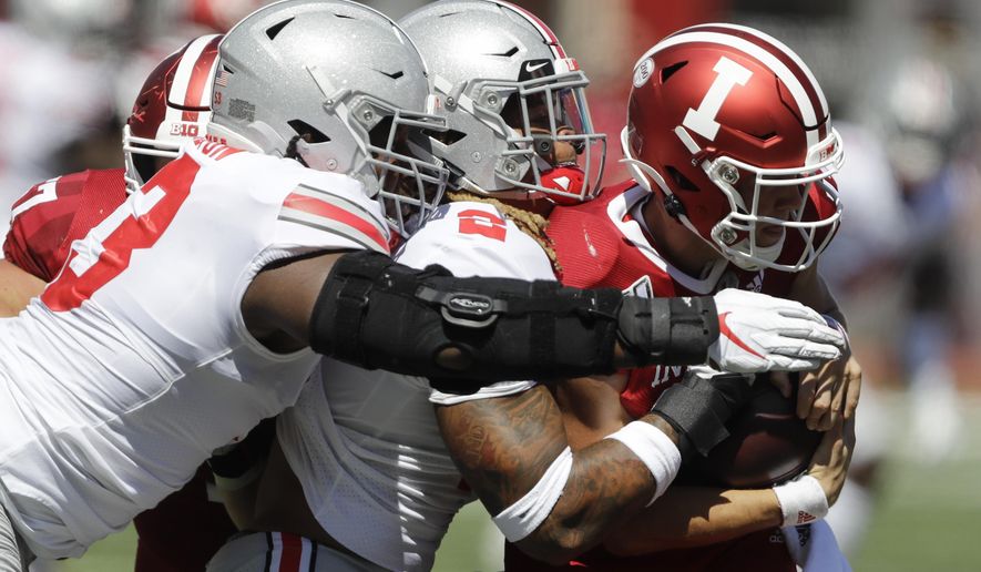 Indiana quarterback Peyton Ramsey (12) is sacked by Ohio State defensive end Chase Young (2) and defensive tackle Davon Hamilton (53) during the first half of an NCAA college football game, Saturday, Sept. 14, 2019, in Bloomington, Ind. (AP Photo/Darron Cummings)
