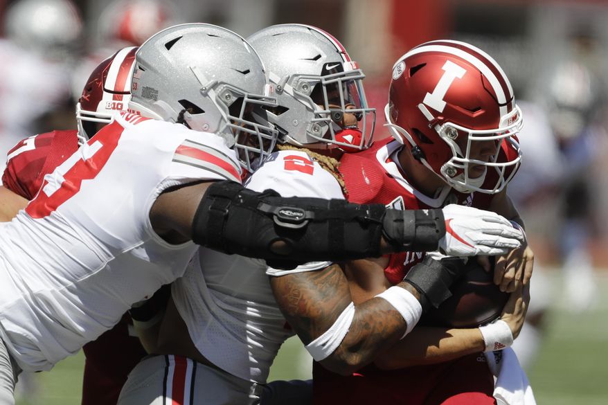Indiana quarterback Peyton Ramsey (12) is sacked by Ohio State defensive end Chase Young (2) and defensive tackle Davon Hamilton (53) during the first half of an NCAA college football game, Saturday, Sept. 14, 2019, in Bloomington, Ind. (AP Photo/Darron Cummings)