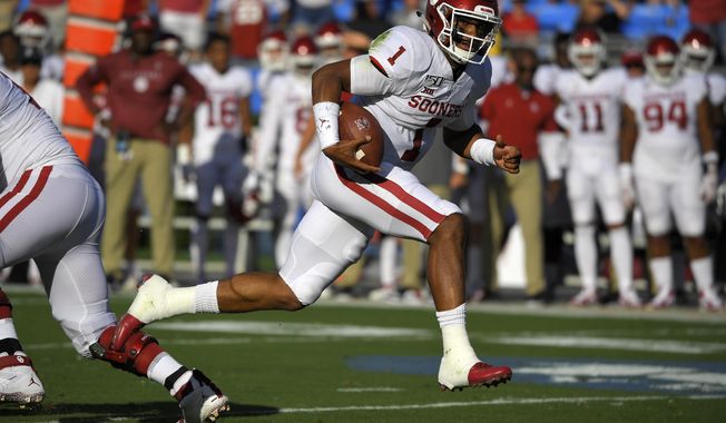 Oklahoma quarterback Jalen Hurts runs in for a touchdown during the first half of the team&#x27;s NCAA college football game against UCLA on Saturday, Sept. 14, 2019, in Pasadena, Calif. (AP Photo/Mark J. Terrill)