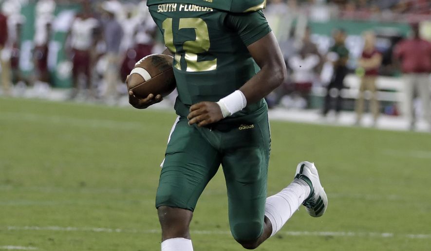 South Florida quarterback Jordan McCloud (12) runs into the end zone for a touchdown against South Carolina State during the second half of an NCAA college football game Saturday, Sept. 14, 2019, in Tampa, Fla. (AP Photo/Chris O'Meara)