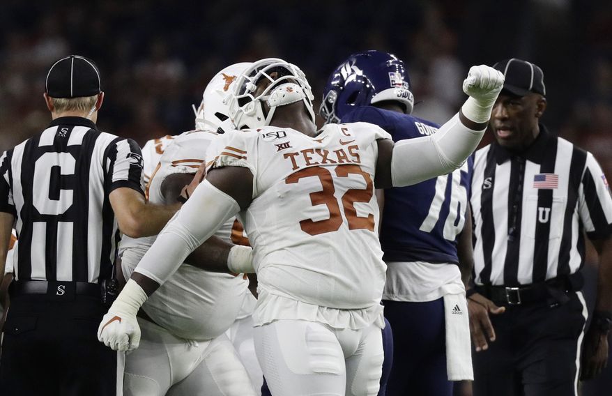 Texas defensive lineman Malcolm Roach (32) celebrates a stop against Rice during the first half of an NCAA college football game Saturday, Sept. 14, 2019, in Houston. (AP Photo/Eric Gay)