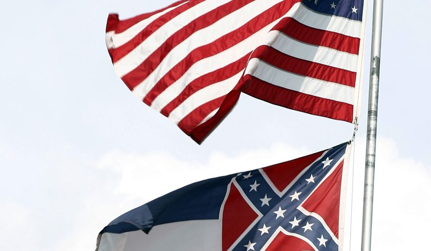 In this Oct. 8, 2015 photograph, the American and Mississippi state flags fly on a flag pole outside the City Hall in McComb, Miss. It&amp;#8217;s a divisive issue that makes politicians squirm: Should Mississippi remove a Confederate battle emblem from its state flag, or stick with the banner it has flown since Reconstruction?  (AP Photo/Rogelio V. Solis)