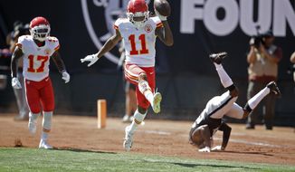 Kansas City Chiefs wide receiver Demarcus Robinson (11) celebrates after scoring a touchdown as teammate Mecole Hardman (17) looks on during the first half of an NFL football game against the Oakland Raiders Sunday, Sept. 15, 2019, in Oakland, Calif. At right is Oakland Raiders cornerback Gareon Conley. (AP Photo/Ben Margot)