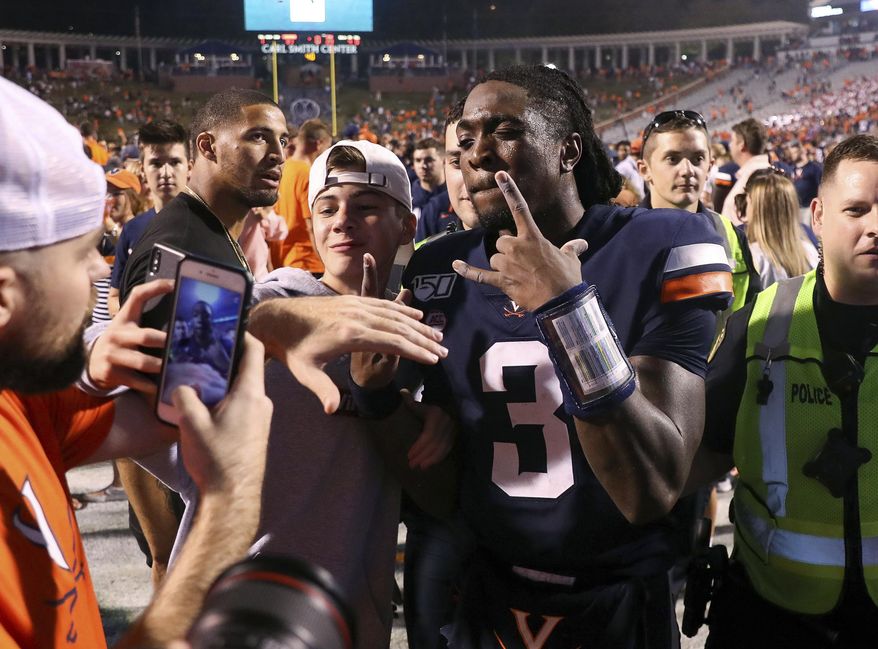 Virginia quarterback Bryce Perkins (3) celebrates with fans after Virginia defeated Florida State 31-24 during an NCAA college football game in Charlottesville, Va., Saturday, Sept. 14, 2019. (AP Photo/Andrew Shurtleff)
