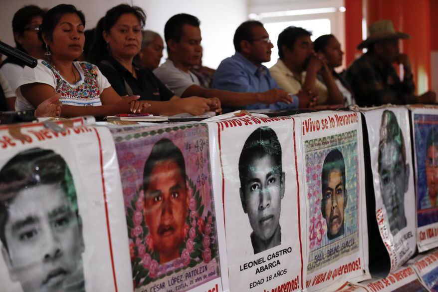 Parents of some of the 43 missing teacher's college students sit behind posters depicting their missing loved ones, during a press conference following a private meeting they had with President Andres Manuel Lopez Obrador, in Mexico City, Wednesday, Sept. 11, 2019. As the fifth anniversary of the students' disappearance at the hands of police approaches, relatives complained Wednesday that progress in the case has been too slow and some institutions are uncooperative. (AP Photo/Rebecca Blackwell)