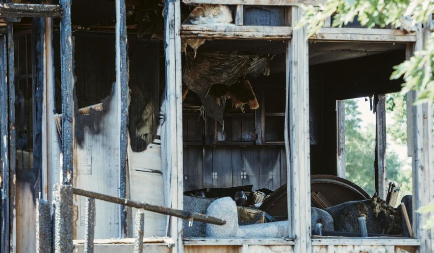 ADVANCE ON THURSDAY, SEPT. 12 FOR USE ANY TIME AFTER 3:01 A.M. SUNDAY SEPT 15 - In this Aug, 28, 2019 photo the burned frame of a mobile home sits on Coronado Street in the Hill-N-Park subdivision near Greeley, Colo. A woman escaped with no injuries when the home caught fire in February 2017. More than two years later, the remains continue to be an eyesore for residents in the neighborhood. The original owner died, and Weld County officials have had difficulty finding heirs, successors or assigns to hold accountable for the property. (Natalie Dyer/Greeley Tribune via AP)