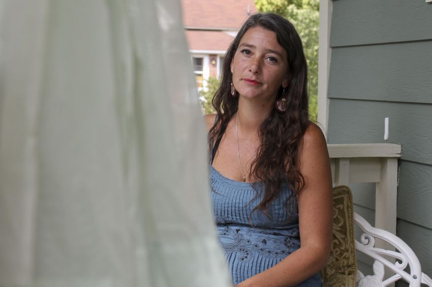 ADVANCE ON THURSDAY, SEPT. 12 FOR USE ANY TIME AFTER 3:01 A.M. SUNDAY SEPT 15 - In this Aug. 23, 2019. In 2013, photo Amanda Anderson stands on the porch of her new house in Lyons, Colo., her mobile home was destroyed during historic flooding and she was not able to rebuild it when Riverbend Mobile Home Park subsequently shut down. When the flood waters in 2013 subsided, evacuees along Colorado's Front Range struggled to return to their homes. For mobile home owners, it was even tougher. Once a flood hits a mobile home park, an array of factors works against them ever reopening. That includes policies that drag out rebuilding and legal squabbles between landowners and officials tasked with charting recovery. (Michael de Yoanna/KUNC public radio via AP)