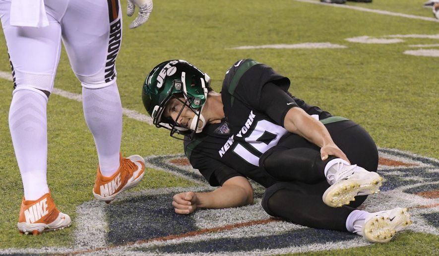 New York Jets quarterback Trevor Siemian (19) grabs his leg after being hurt during the first half of an NFL football game against the Cleveland Browns, Monday, Sept. 16, 2019, in East Rutherford, N.J. (AP Photo/Bill Kostroun)