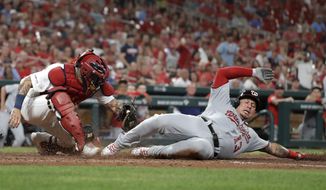 Washington Nationals&#x27; Asdrubal Cabrera (13) is tagged out at home by St. Louis Cardinals catcher Yadier Molina during the fourth inning of a baseball game Monday, Sept. 16, 2019, in St. Louis. (AP Photo/Jeff Roberson)