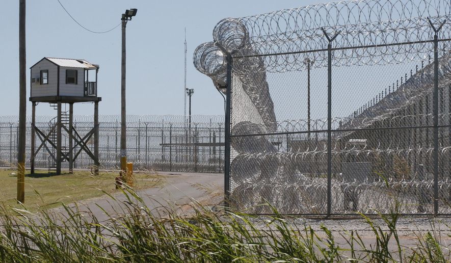 FILE - This July 10, 2017, file photo shows a tower outside of the razor wire at the Great Plains Correctional Facility in Hinton, Okla. Prisons in Oklahoma are locked down after several inmate fights over the weekend caused one inmate death and more than a dozen injuries. (AP Photo/Sue Ogrocki, File)