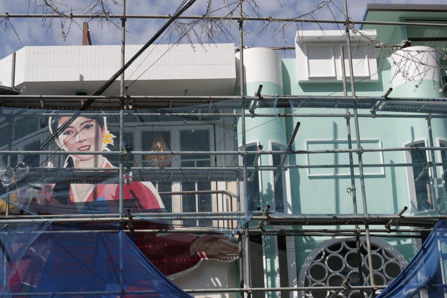 Empty frames, right top and right center, are seen after the removal of the signs with the portrait of North Korean leaders and the image of a North Korean flag from the restaurant's exterior wall of the North Korea-themed restaurant under construction in Seoul, South Korea, Monday, Sept. 16, 2019. North Korea-themed restaurant in Seoul removes Kim portrait and flag image as police look into whether owner violated security law.(AP Photo/Lee Jin-man)