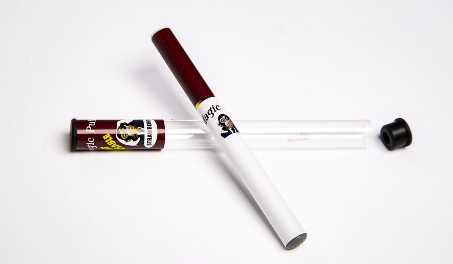 This Wednesday, July 17, 2019, photo shows a Magic Puff electronic cigarette and its packaging in Los Angeles. The product is labeled as a disposable hemp pen and was being sold as delivering the cannabis extract CBD at a store in Panama City, Florida, in July. Testing commissioned by The Associated Press as part of an investigation into CBD found it actually contained synthetic marijuana, a dangerous street drug commonly known as K2 or spice. (AP Photo/Damian Dovarganes) ** FILE **