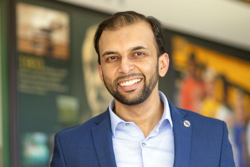 FILE - In this March 23, 2019 file image provided by the campaign of Qasim Rashid, state Senate candidate Qasim Rashid poses at the Stafford County Courthouse in Stafford, Va. A federal judge refused Monday, Sept. 16, 2019 to throw out a case in which a North Carolina man is charged with anonymously threatening to lynch Qasim Rashid, a Muslim-American man who is campaigning for a state Senate seat in Virginia. (Marion Meakem Photography/Quasim Rashid Campaign via AP, File)