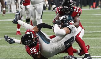 Philadelphia Eagles tight end Zach Ertz (86) is stopped for a first down by Atlanta Falcons free safety Isaiah Oliver (26) Atlanta Falcons strong safety Keanu Neal (22) during the second half of an NFL football game, Sunday, Sept. 15, 2019, in Atlanta. The Atlanta Falcons won 24-20. (AP Photo/John Bazemore)