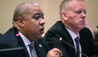 Baltimore Police Commissioner Michael Harrison, left, gives a presentation before the Commission to Restore Trust in Policing during a hearing on Tuesday, Sept. 17, 2019 in Annapolis, Maryland, with Brian Nadeau, deputy police commissioner, right. (AP Photo/Brian Witte)
