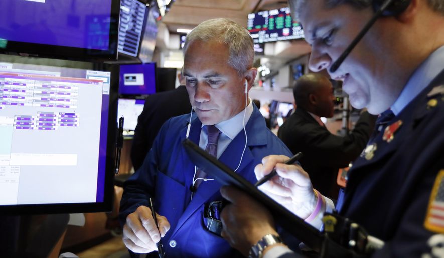 FILE - In this Sept. 13, 2019, file photo trader Timothy Nick, left, works on the floor of the New York Stock Exchange. The U.S. stock market opens at 9:30 a.m. EDT on Tuesday, Sept. 17. (AP Photo/Richard Drew)