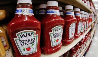 FILE- This Feb. 21, 2018, file photo shows a display of Heinz Ketchup on display in a market in Pittsburgh. Kraft Heinz Co. shares are sliding on Tuesday, Sept. 17, 2019, after one of the company’s top investors sold 25 million shares. (AP Photo/Gene J. Puskar, File)