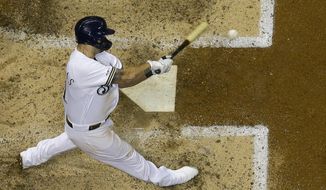 Milwaukee Brewers&#39; Mike Moustakas hits a home run during the seventh inning of a baseball game against the San Diego Padres Tuesday, Sept. 17, 2019, in Milwaukee. (AP Photo/Morry Gash)