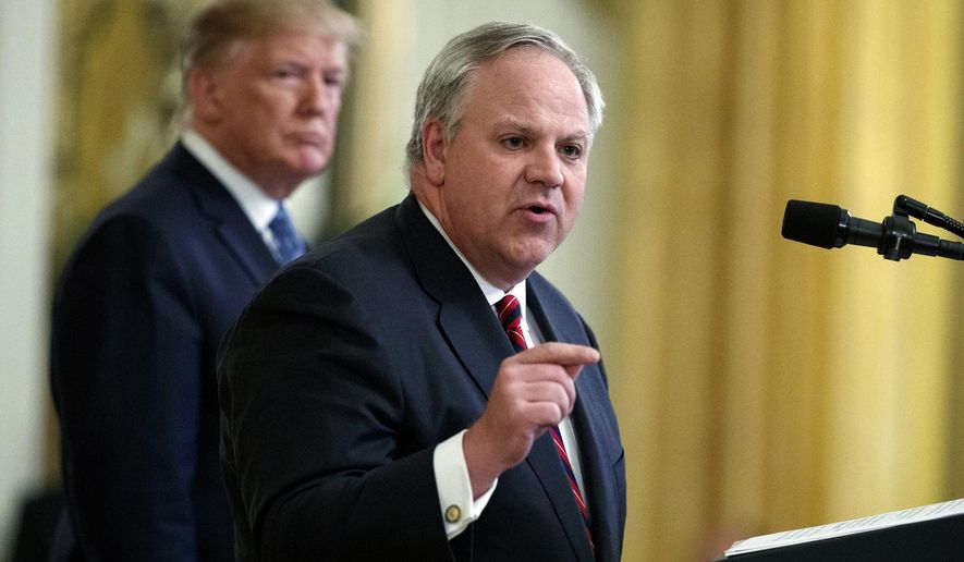 FILE - In this July 8, 2019, file photo President Donald Trump listens as then-Secretary of the Interior David Bernhardt speaks during an event on the environment in the East Room of the White House in Washington. In less than three years, Trump has named more former lobbyists to Cabinet-level posts than his most recent predecessors did in eight, putting a substantial amount of oversight in the hands of people with ties to the industries they’re regulating. (AP Photo/Evan Vucci, File)