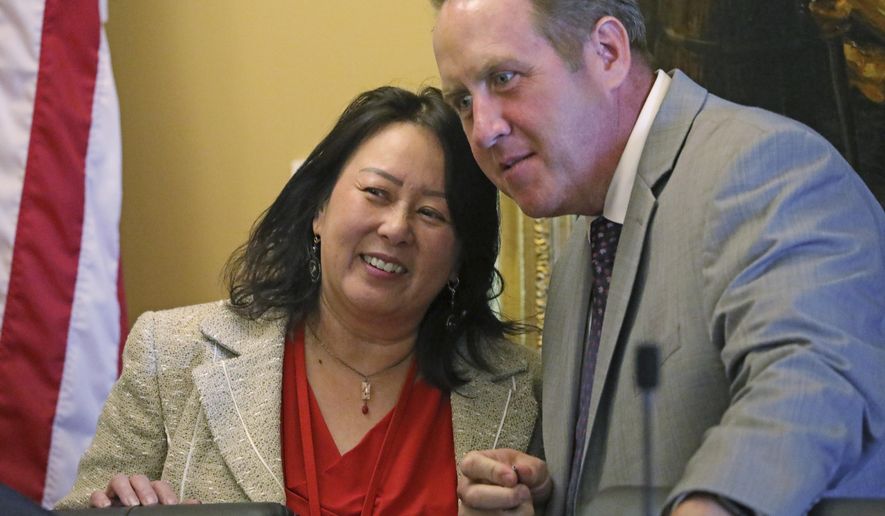 In this Monday, Sept. 16, 2019, photo, Rep. Karen Kwan and Rep. Jefferson Moss speak during a committee hearing at the Utah State Capitol, in Salt Lake City. Utah is the latest of nearly two dozen states across the country that are spending millions of their own money to make sure residents fill out next year's census form amid fears that undercounting could mean losing federal funding or crucial seats in Congress. (AP Photo/Rick Bowmer)