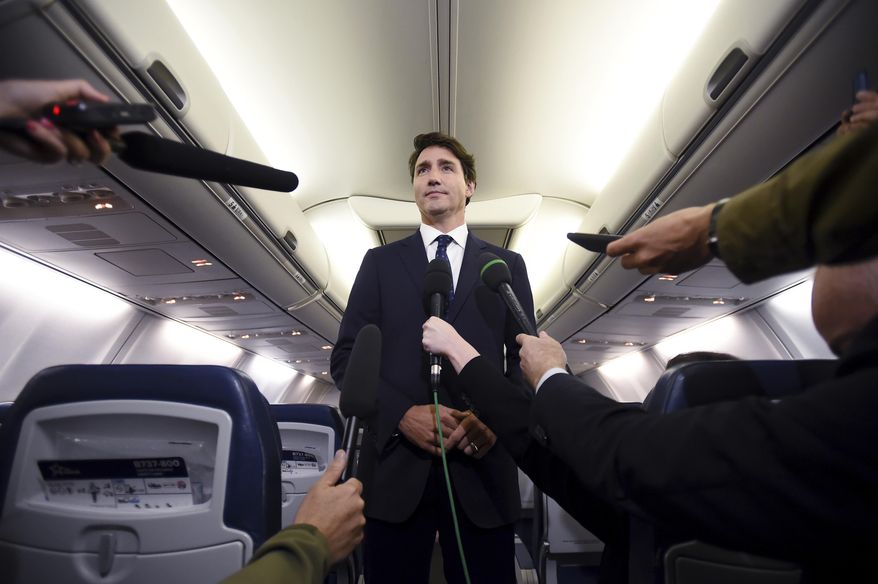 Canadian Prime Minister and Liberal Party leader Justin Trudeau makes a statement in regards to a photo coming to light of himself from 2001, wearing "brownface," during a scrum on his campaign plane in Halifax, Nova Scotia, Wednesday, Sept. 18, 2019. (Sean Kilpatrick/The Canadian Press via AP)