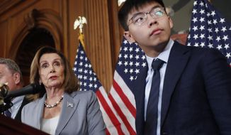 House Speaker Nancy Pelosi, left, with Hong Kong activist Joshua Wong and other members of Congress during a news conference on human right in Hong Kong on Capitol Hill in Washington, Wednesday, Sept. 18, 2019. (AP Photo/Pablo Martinez Monsivais)