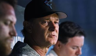 FILE - In this July 16, 2019, file photo, Miami Marlins manager Don Mattingly speaks to members of the media before the start of a baseball game against the San Diego Padres, in Miami. The Dolphins look like the worst team in the NFL, and might even be the worst team in Miami. On the other hand, a comparison with the Marlins is one matchup the Dolphins might win. (AP Photo/Wilfredo Lee, File)