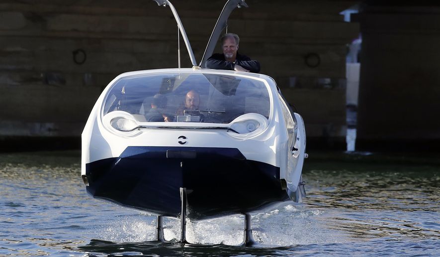 SeaBubbles co-founder Sweden&#x27;s Anders Bringdal stands onboard a SeaBubble, Wednesday Sept. 18, 2019 in Paris. Paris is testing out a new form of travel - an eco-friendly bubble-shaped taxi that zips along the water, capable of whisking passengers up and down the Seine River. Dubbed Seabubbles, the vehicle is still in early stages, but proponents see it as a new model for the fast-changing landscape of urban mobility. (AP Photo/Francois Mori)