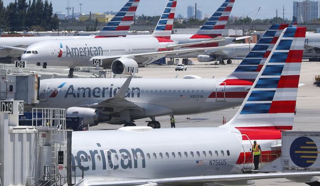 In this April 24, 2019, photo, American Airlines aircraft are shown parked at their gates at Miami International Airport in Miami. A bail hearing is scheduled for a mechanic charged with sabotaging an American Airlines jetliner as part of a labor dispute. Prosecutors are seeking pretrial detention for 60-year-old Abdul-Majeed Marouf Ahmed Alani at a hearing Wednesday, Sept. 18. (AP Photo/Wilfredo Lee, File)