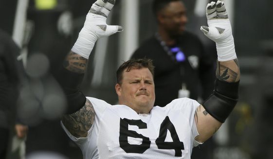 FILE - In this July 29, 2019, file photo, Oakland Raiders center Richie Incognito stretches during NFL football training camp in Napa, Calif. Guard Richie Incognito returns to the Raiders after missing two games for a suspension for violating the NFL&#39;s personal conduct policy. (AP Photo/Eric Risberg, File)