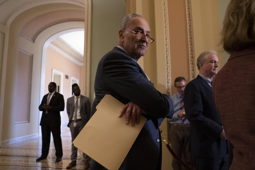 Senate Minority Leader Chuck Schumer, D-N.Y., joined at right by Sen. Chris Van Hollen, D-Md., pauses during a news conference at the Capitol in Washington, Tuesday, Sept. 17, 2019. (AP Photo/J. Scott Applewhite)