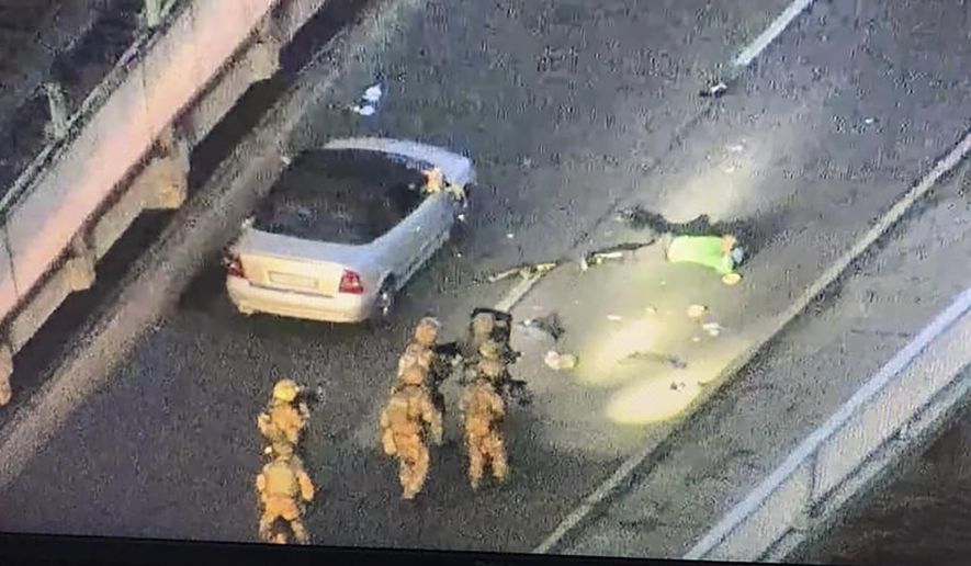 In this image released by the Police Press Service, the view from a police drone in Kyiv, Ukraine, Wednesday, Sept. 18, 2019. Police in the Ukrainian capital Kyiv have seized an armed man who was threatening to blow up a major bridge and who shot down a police drone that was monitoring him. The man made the threats as he stood on the bridge Wednesday afternoon. (Ukrainian Police Press Office via AP)