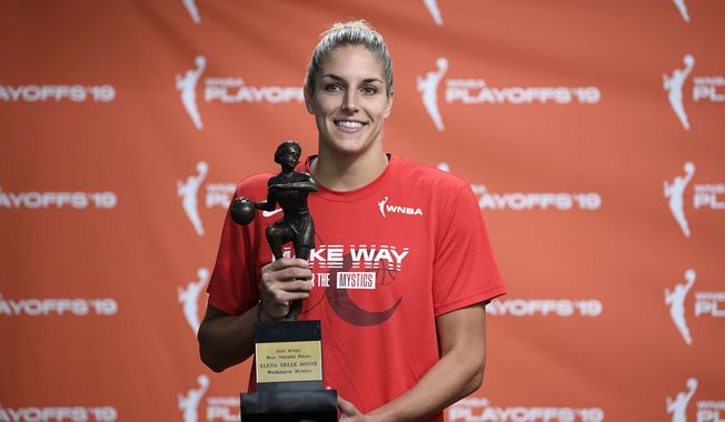 Washington Mystics forward Elena Delle Donne poses with the 2019 WNBA most valuable player trophy at a press conference, Thursday, Sept. 19, 2019, in Washington. (AP Photo/Nick Wass) ** FILE **