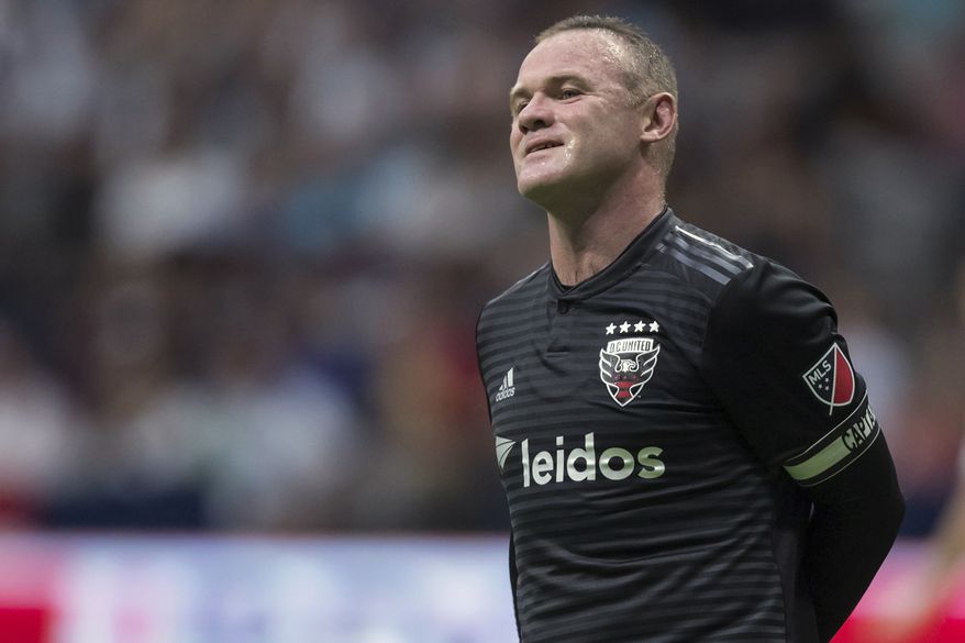  In this Aug. 17, 2019, file photo, D.C. United&#39;s Wayne Rooney reacts after putting a shot over top of the Vancouver Whitecaps&#39; goal during the first half of an MLS soccer match in Vancouver, British Columbia. As his Major League Soccer career draws to a close and he prepares to return home, Wayne Rooney would like one more shot at the playoffs stateside. (Darryl Dyck/The Canadian Press via AP, File)  **FILE**