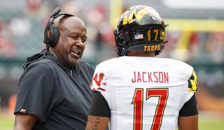 Maryland head coach Michael Locksley talks things over with quarterback Josh Jackson (17) during the first half of an NCAA college football against Temple, Saturday, Sept. 14, 2019, in Philadelphia. Temple won 20-17. (AP Photo/Chris Szagola) ** FILE **